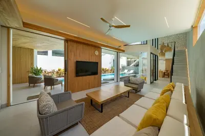 a living room with a couch and a tv at Kona Resort - Seminyak in Kerobokan