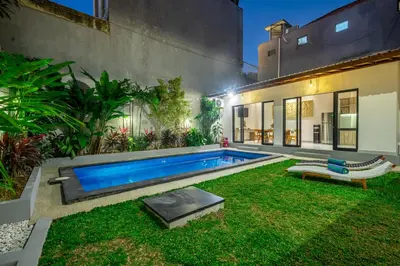 a swimming pool in the yard of a house at Villa Lebah Seminyak in Seminyak