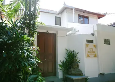 a house with a wooden door and some plants at Villa Lebah Seminyak in Seminyak