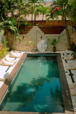 a swimming pool in the middle of a yard at Villa Vela 6 BR Seminyak in Seminyak