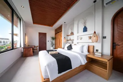 a bedroom with a large bed and a window at New Luxury villa walk to Atlas, Finns and Berawa beach in Canggu