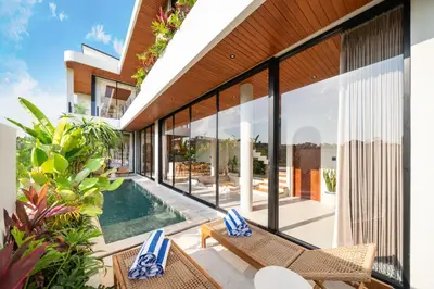 an external view of a villa with a swimming pool at New Luxury villa walk to Atlas, Finns and Berawa beach in Canggu
