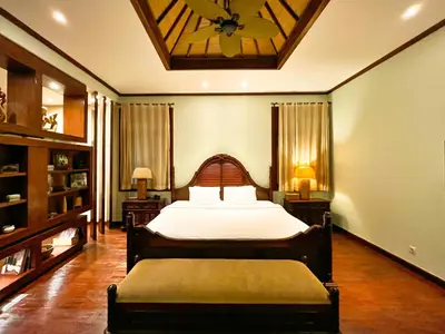 a bedroom with a bed and a clock on the ceiling at Villa Michelle Bali in Seminyak