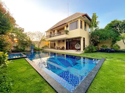 a house with a swimming pool in the yard at Villa Michelle Bali in Seminyak