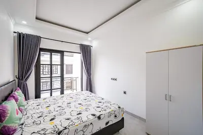 a bedroom with a bed and a window at Aurelia Home at Mogan Residence in Seminyak