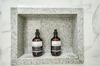 two bottles of wine sitting in a stone holder at Aurelia Home at Mogan Residence in Seminyak
