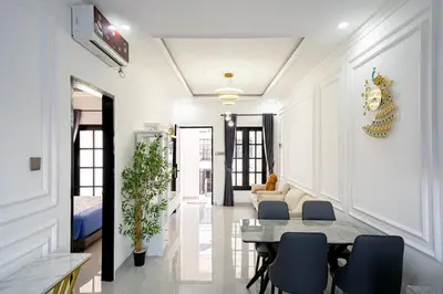 a living room with a table and chairs at Aurelia Home at Mogan Residence in Seminyak