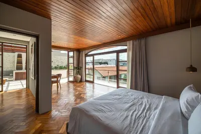 a bedroom with a bed with a wooden ceiling at Sonaa Villa Bali in Canggu
