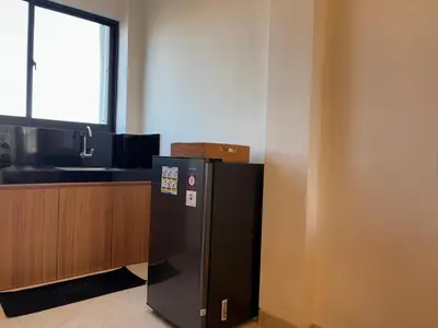 a black refrigerator in a room with a counter at Taman Sari Guesthouse in Kerobokan