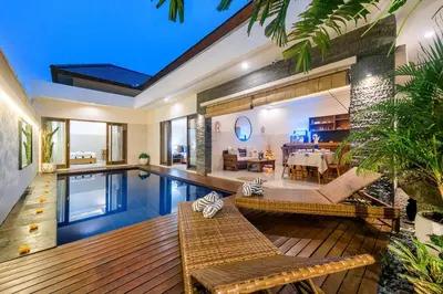 a house with a swimming pool and a dining room at Adikara Villa 2 Cozy 2BR in Canggu, Berawa 5 mins to the beach in Canggu