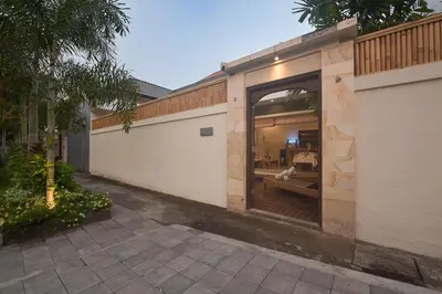 a house with a large window on the side of it at Adikara Villa 2 Cozy 2BR in Canggu, Berawa 5 mins to the beach in Canggu