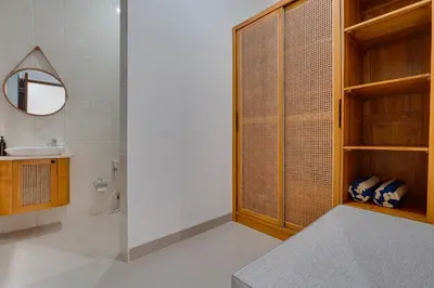 a bathroom with a shower and a sink and a mirror at Stylish 3BR Villa Palm Haven 11 near Central Seminyak in Seminyak