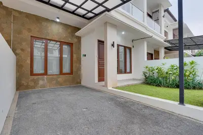 an empty house with a porch and a driveway at Stylish 3BR Villa Palm Haven 11 near Central Seminyak in Seminyak