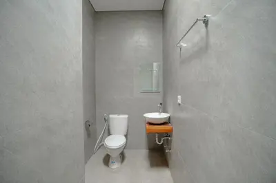 a bathroom with a toilet and a sink at Abimanyu Guest House in Seminyak