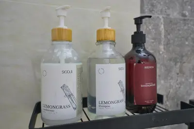 three bottles of wine sitting on a shelf at Luxury Villa 3br 5min to Seminyak beach in Seminyak