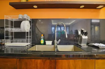 a kitchen counter with a sink and two bird cages at Luxury Villa 3br 5min to Seminyak beach in Seminyak