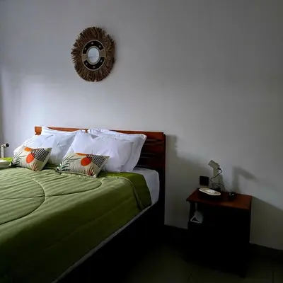 a bedroom with a bed with a mirror on the wall at Brand New! Villa Putu Seminyak in Kerobokan