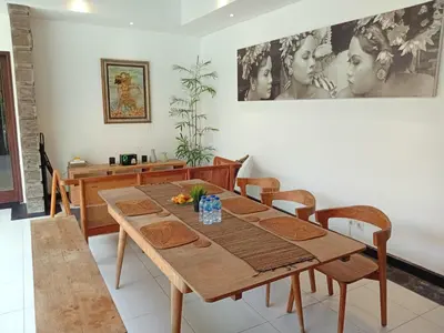 a dining room with a wooden table and chairs at Villa Diraya 2 Bedroom Villa in Kerobokan in Kerobokan