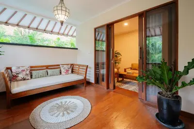 a living room with a couch and a potted plant at New Villa 50 Seminyak in Seminyak