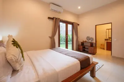 a bedroom with a bed and a large window at New Villa 50 Seminyak in Seminyak