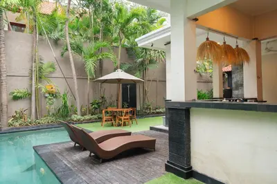 a house with a swimming pool and a patio at New Villa 50 Seminyak in Seminyak