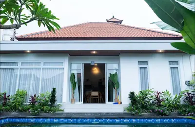 a white house with a red roof at GB UNLU Villas in Kerobokan