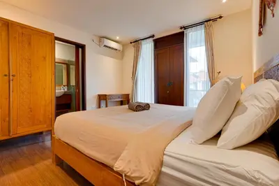 a bedroom with a large bed with white pillows at Family 3BR Villa Laviosa in Petitenget near Beach in Seminyak