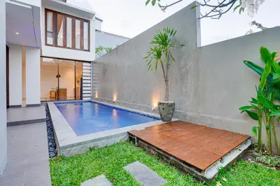 a swimming pool in the backyard of a house at Family 3BR Villa Laviosa in Petitenget near Beach in Seminyak