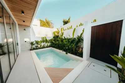 a hot tub in the backyard of a house at La Payesa 2 in Canggu