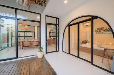 a home with large windows and a dining room at 4BR Modern Villa walking dist to Sidewalk Jimbaran in Jimbaran