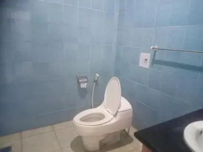 a bathroom with a white toilet and a sink at Villa Private In Kuta Bali in Kuta