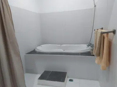 a small bathroom with a toilet and a sink at Villa Private In Kuta Bali in Kuta