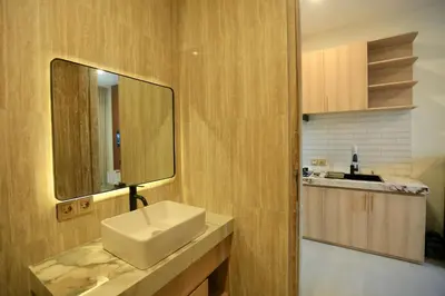 a bathroom with a sink and a mirror at Luminera Bali Apartment in Nusa Dua