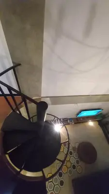 a room with a table and a light on the ceiling at Arzella Apartment in Seminyak