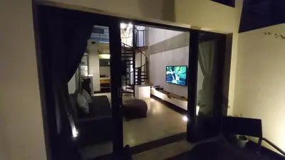 a view of a living room with a television at Arzella Apartment in Seminyak