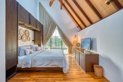 a bedroom with a bed and a large window at New! Architectural 2BR Villa near Seminyak in Kerobokan