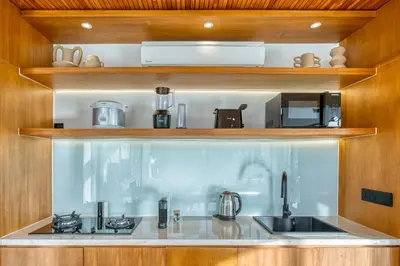 a kitchen with a sink and a stove at New! Architectural 2BR Villa near Seminyak in Kerobokan