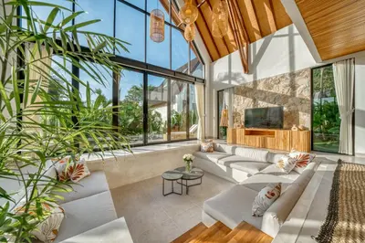 a living room with large windows and white couches at New! Architectural 2BR Villa near Seminyak in Kerobokan