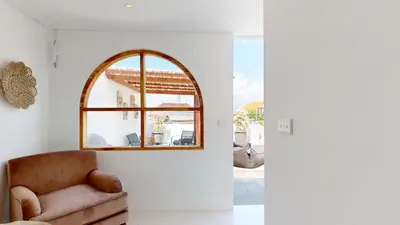 a living room with a chair and a window at Minimalist & Bohemian 2Br Villa in Seminyak in Seminyak