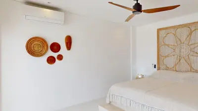 a bedroom with a bed and a ceiling fan at Minimalist & Bohemian 2Br Villa in Seminyak in Seminyak