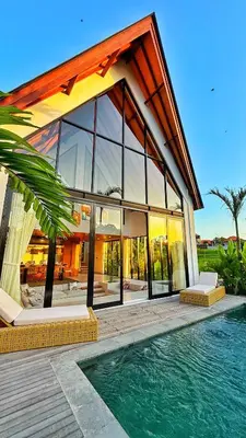 a large house with a pool in front of it at New! Designer Arch Villa with pool near Seminyak in Kerobokan