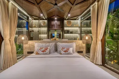 a bedroom with a large bed with windows at New Sleek 1BR Retreat with Pool Near Seminyak in Kerobokan