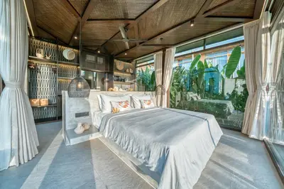 a bedroom with a bed and a large window at New Sleek 1BR Retreat with Pool Near Seminyak in Kerobokan