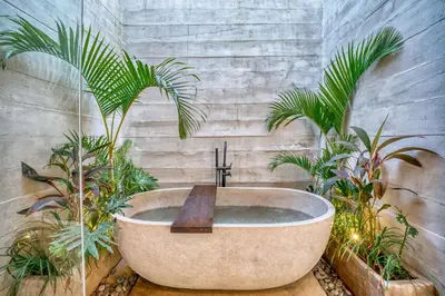 a bathroom with a bath tub with plants at New Tranquil Jungle View Villa in Kerobokan in Kerobokan