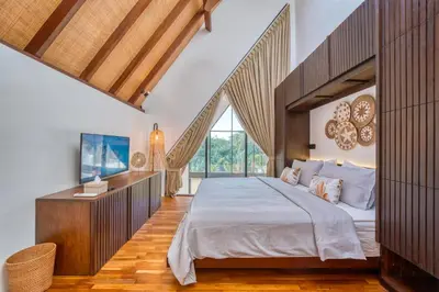 a bedroom with a large bed and a large window at New Tranquil Jungle View Villa in Kerobokan in Kerobokan