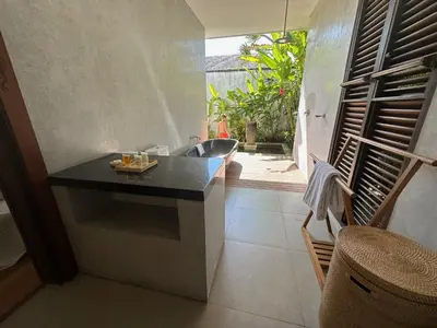 a bathroom with a sink and a bath tub at Saba Villas in Canggu