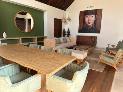 a living room with a wooden table and chairs at Saba Villas in Canggu