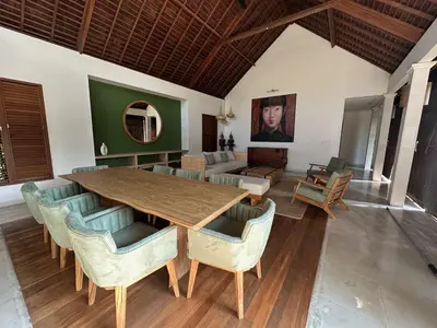a dining room with a wooden table and chairs at Saba Villas in Canggu