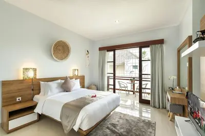 a bedroom with a large bed and a television at 5 Reviews, Huge Savings Best Locale In Seminyak in Badung