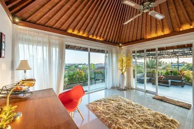 a living room with a ceiling fan and a table and chairs at 5 Reviews, Huge Savings Best Locale In Seminyak in Badung